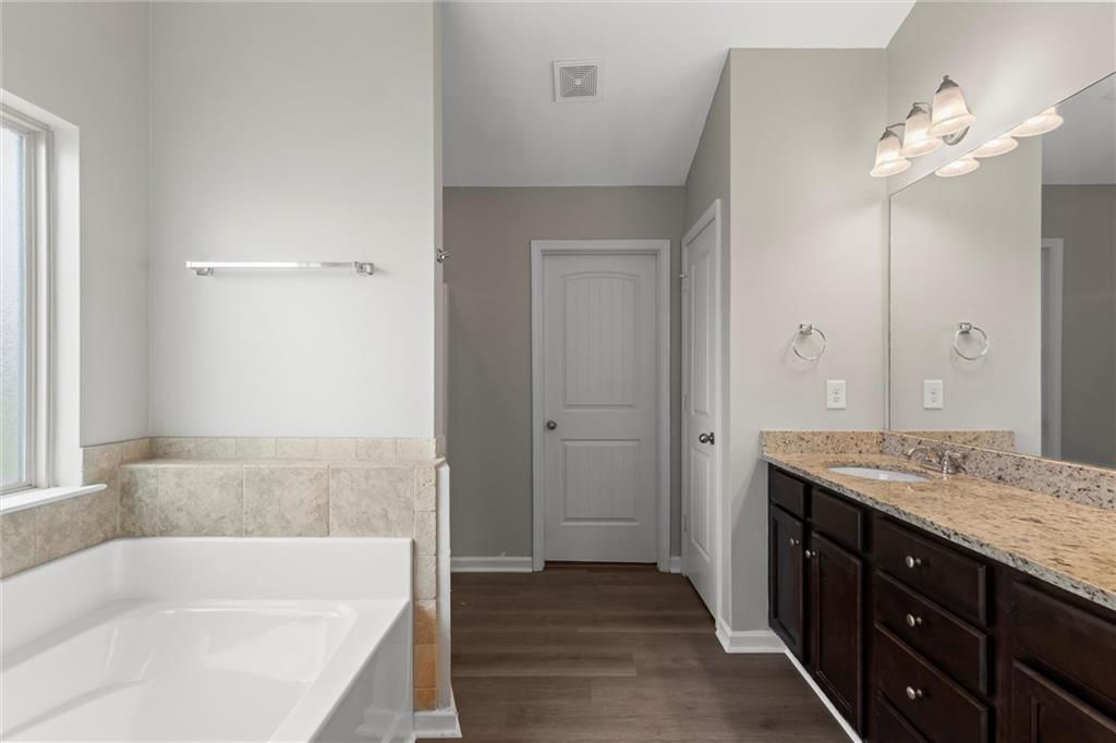 9120 Alden Drive Locust Grove, GA 30248 - Photo 29 of 39 a bathroom with a tub sink and mirror