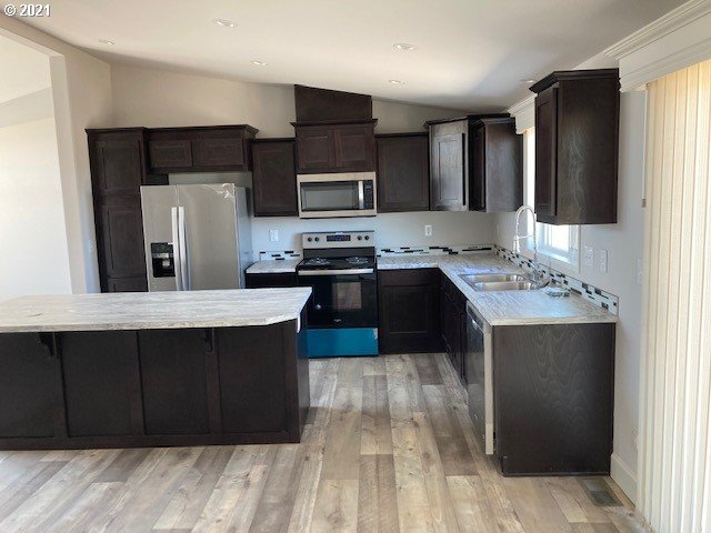 3121 Southwest Terrace Drive Pendleton, OR 97801 - Photo 8 of 21 a kitchen with stainless steel appliances a sink stove and refrigerator