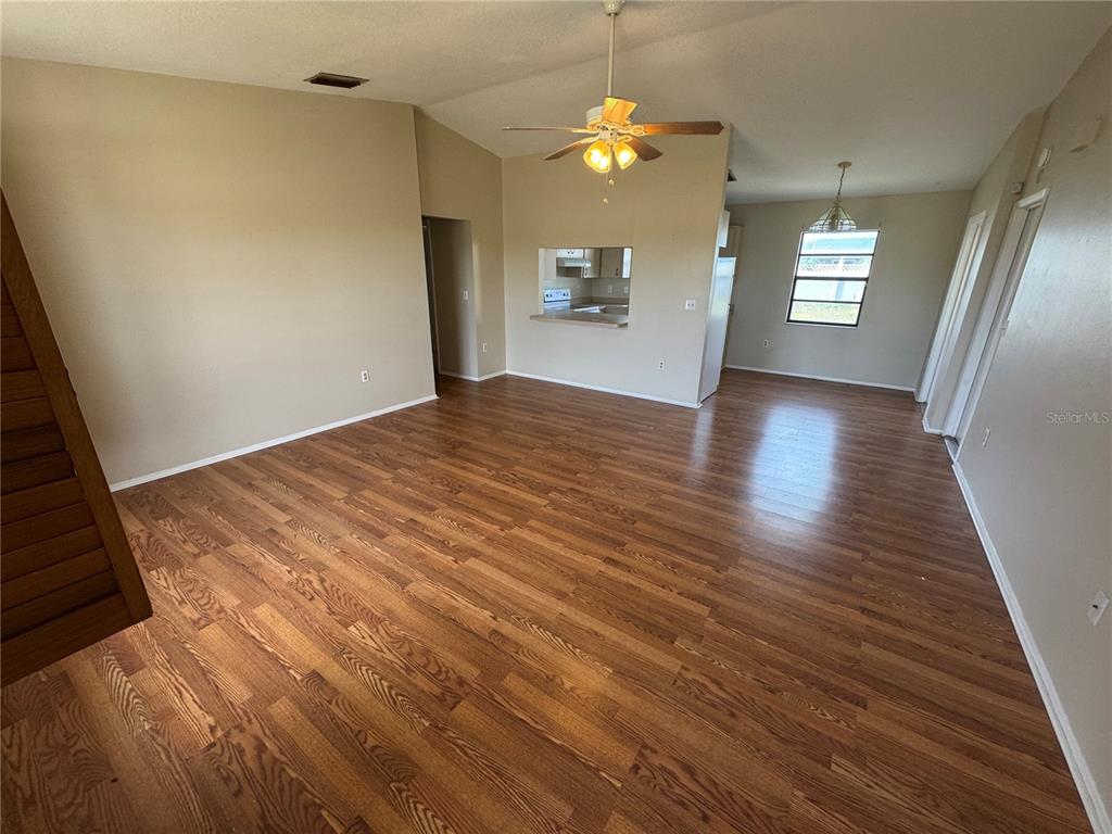 1786 Dagon Road Venice, FL 34293 - Photo 3 of 18 wooden floor in an empty room with a window