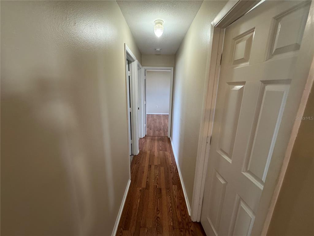 1786 Dagon Road Venice, FL 34293 - Photo 7 of 18 a view of a hallway with wooden floor
