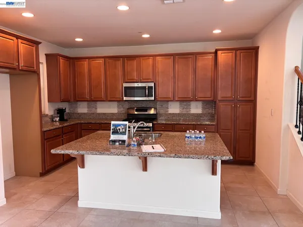 a kitchen with a sink appliances and cabinets
