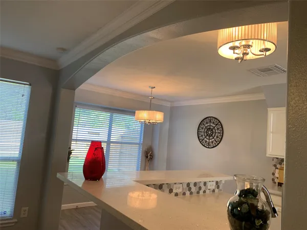 a view of a room with kitchen island and stainless steel appliances