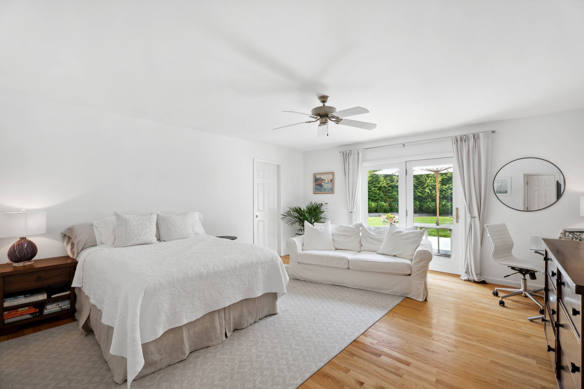 29 Emerson Place Sag Harbor, NY 11963 - Photo 12 of 23 a bedroom with a bed a chandelier couches and fireplace