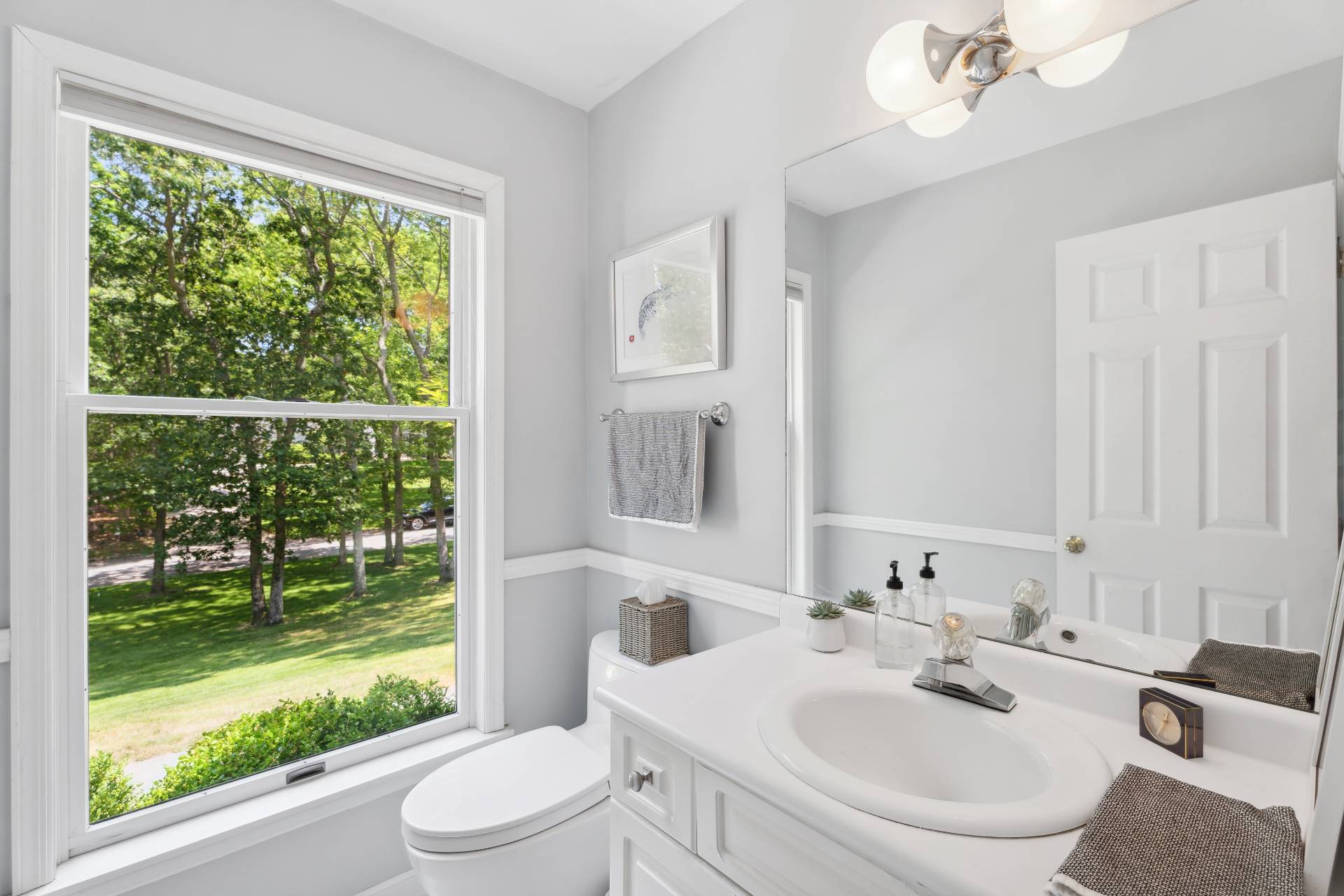 29 Emerson Place Sag Harbor, NY 11963 - Photo 19 of 23 a bathroom with a sink toilet and a mirror