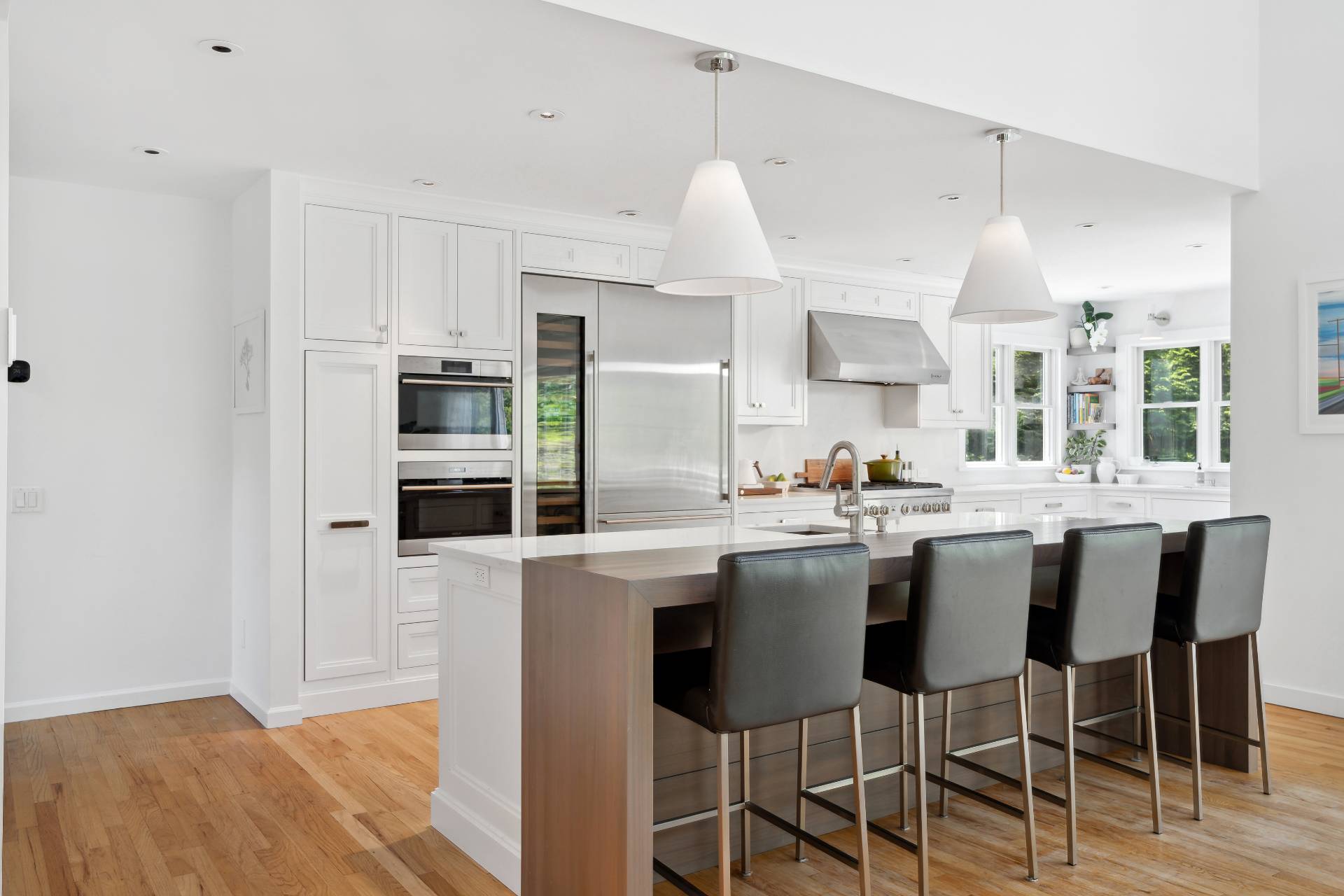 29 Emerson Place Sag Harbor, NY 11963 - Photo 6 of 23 a kitchen with stainless steel appliances a dining table chairs and sink