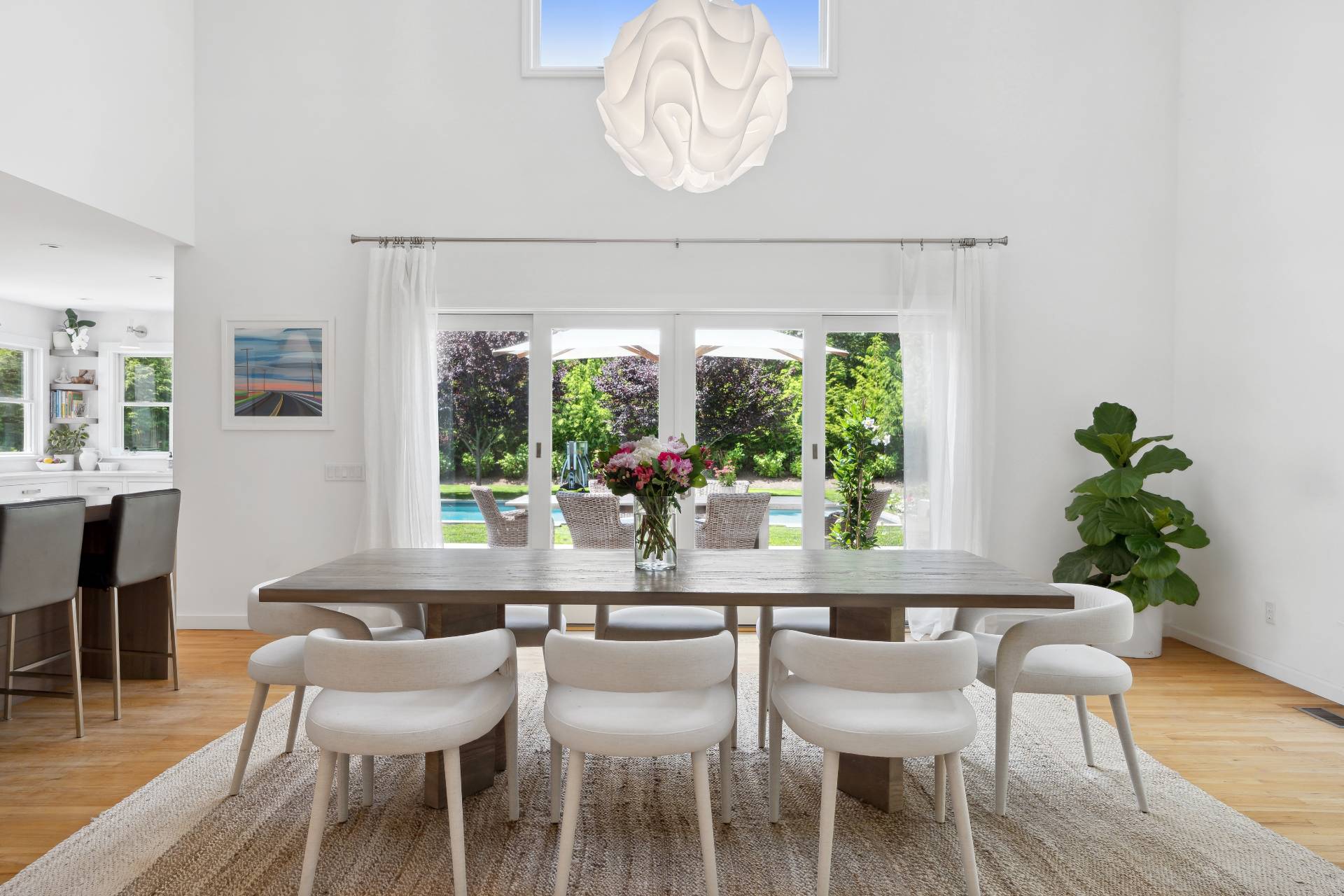 29 Emerson Place Sag Harbor, NY 11963 - Photo 9 of 23 a dining room with furniture a potted plant and a chandelier