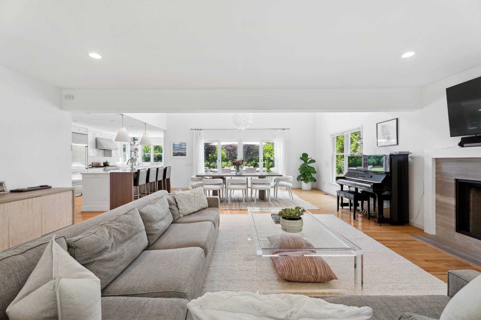 29 Emerson Place Sag Harbor, NY 11963 - Photo 10 of 23 a living room with furniture and a flat screen tv with kitchen view