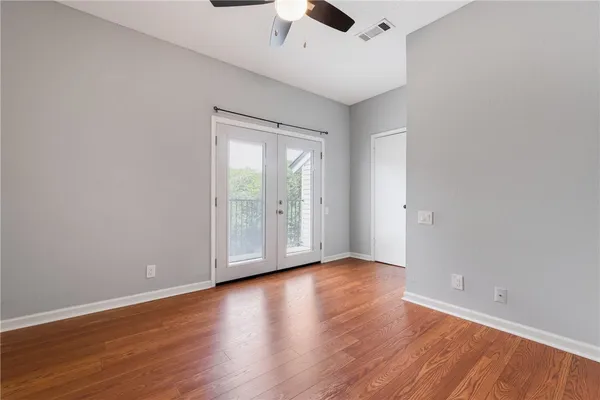 a view of an empty room with wooden floor