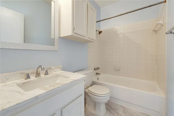 a bathroom with a sink a toilet and a bathtub