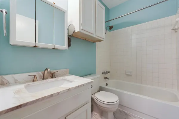 a bathroom with a sink a toilet and a bathtub