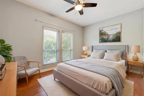 a bedroom with a large bed and a chandelier