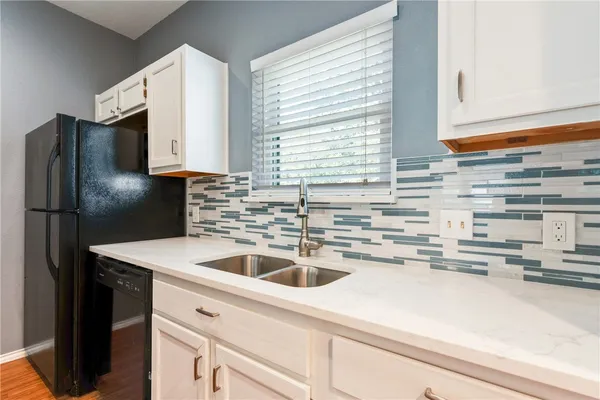 a kitchen with kitchen island a sink a counter appliances and cabinets