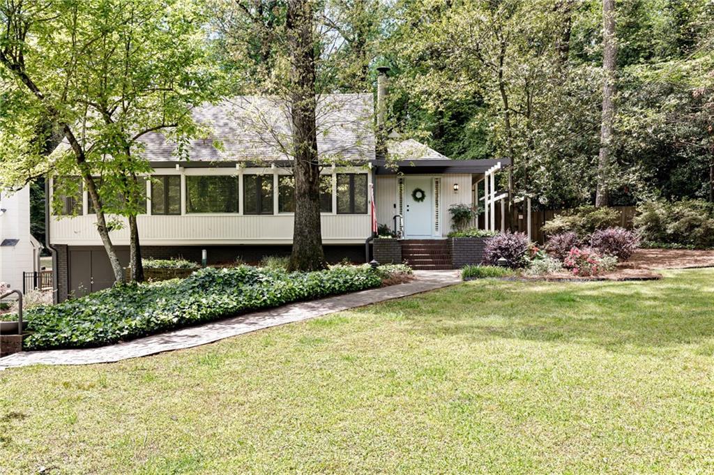 2466 Ridgewood Road Northwest Atlanta, GA 30318 - Photo 1 of 1 a front view of a house with a yard
