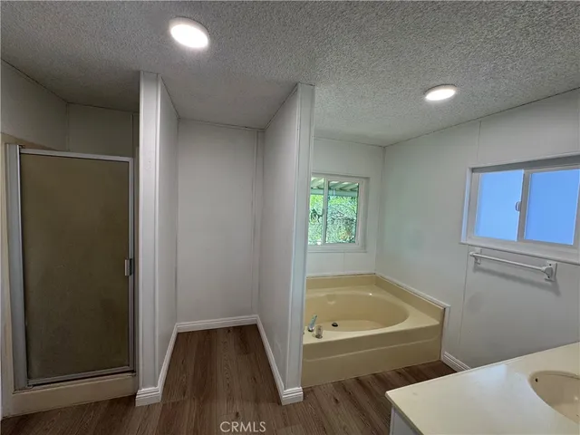 a bathroom with a tub and toilet