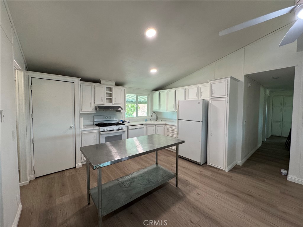 37065 Bonita Vista Road Anza, CA 92539 - Photo 16 of 65 a kitchen with a refrigerator and a stove top oven