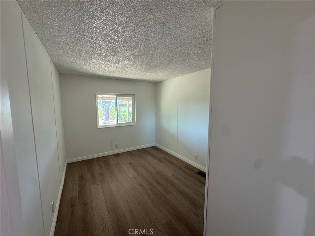 37065 Bonita Vista Road Anza, CA 92539 - Photo 18 of 65 an empty room with wooden floor and windows