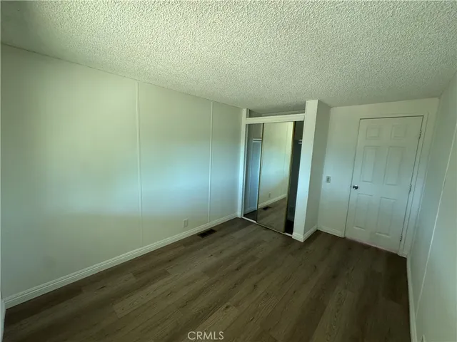 an empty room with wooden floor