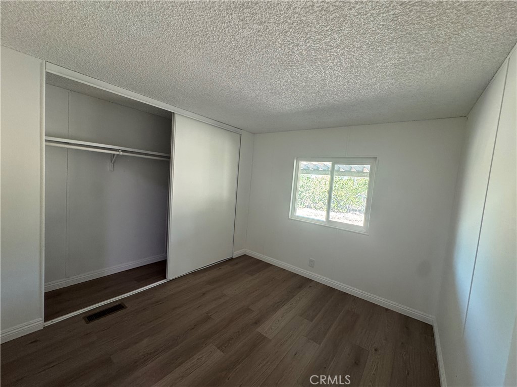 37065 Bonita Vista Road Anza, CA 92539 - Photo 20 of 65 an empty room with wooden floor and windows