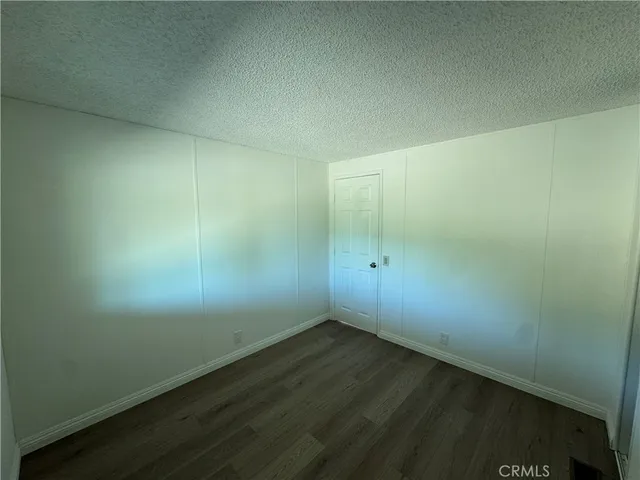 an empty room with wooden floor