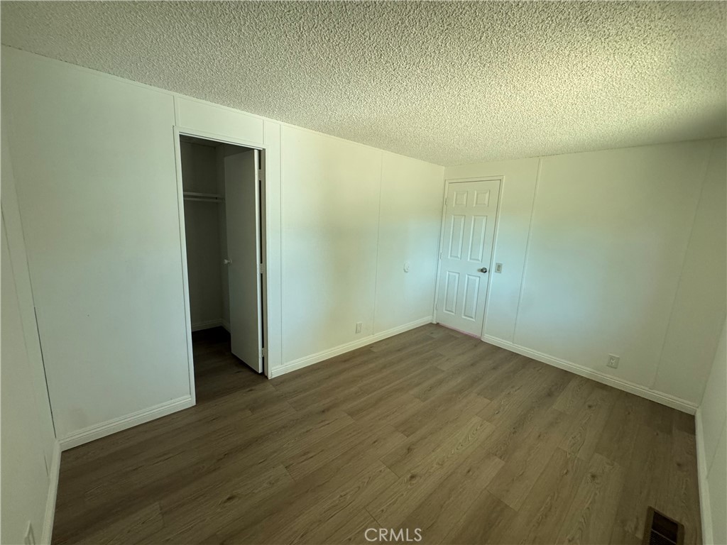 37065 Bonita Vista Road Anza, CA 92539 - Photo 28 of 65 an empty room with wooden floor and closet