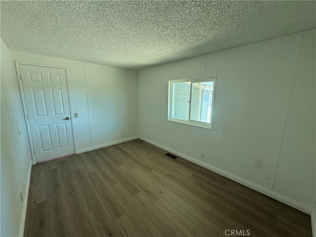 37065 Bonita Vista Road Anza, CA 92539 - Photo 29 of 65 an empty room with wooden floor and windows