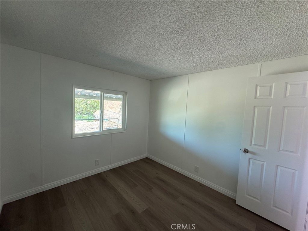 37065 Bonita Vista Road Anza, CA 92539 - Photo 30 of 65 an empty room with wooden floor and window