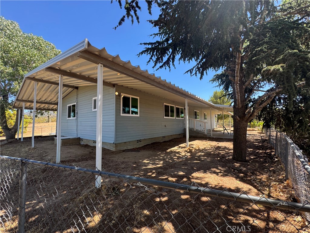 37065 Bonita Vista Road Anza, CA 92539 - Photo 37 of 65 a backyard of a house with table and chairs under an umbrella