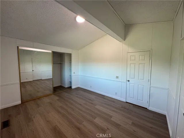 a view of wooden floor and windows in a room