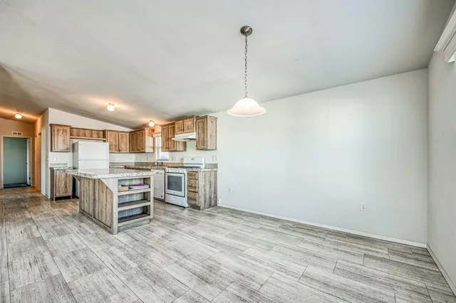a view of a kitchen with microwave and cabinets