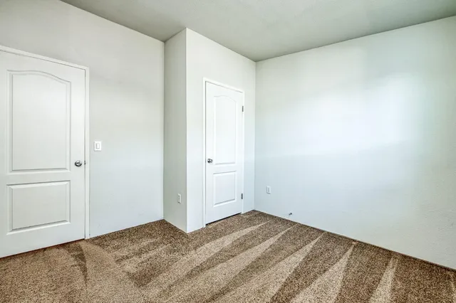 a view of a room that has a bed in it