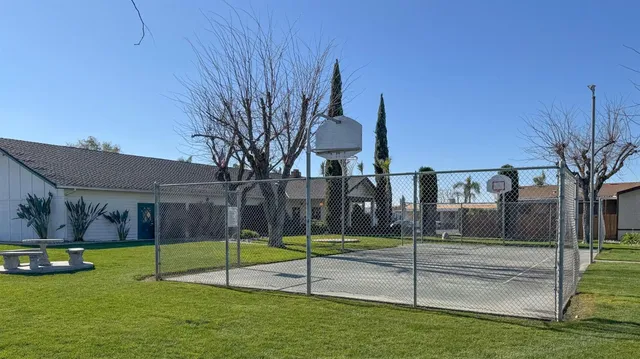 a view of a park with iron fence