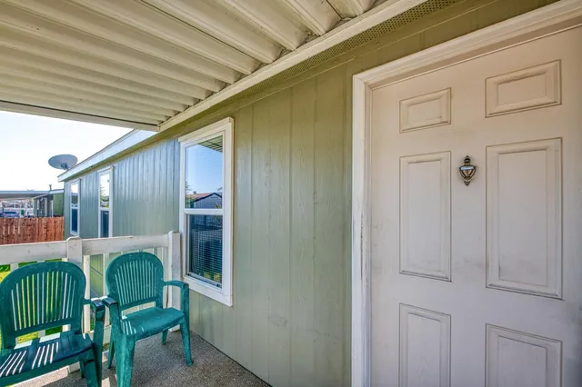 a backyard of a house with table and chairs