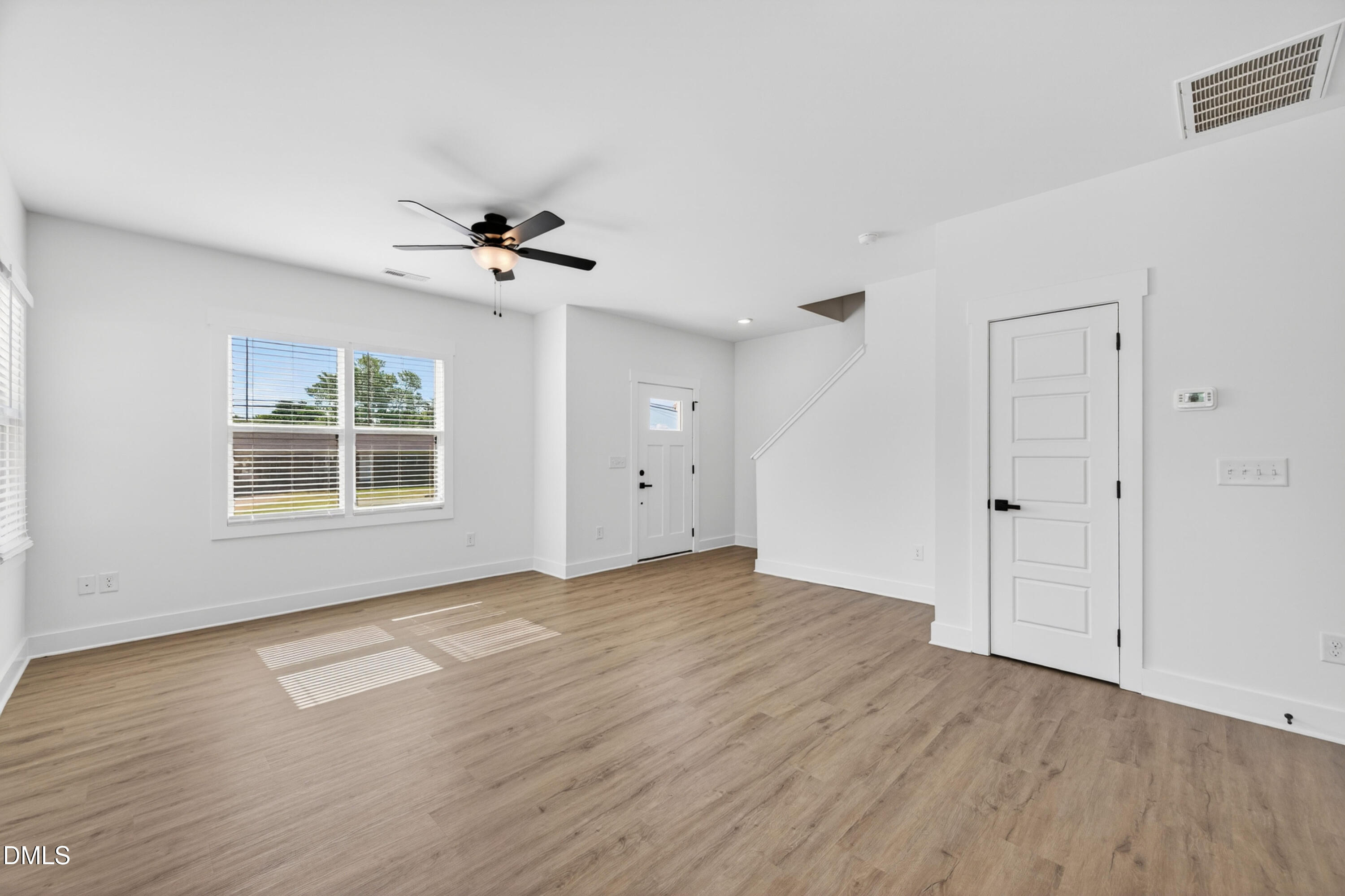 1196 Hurdle Mills Road Roxboro, NC 27573 - Photo 12 of 50 a view of an empty room with a window and wooden floor