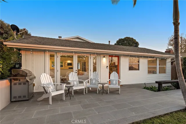 a view of a patio with table and chairs and potted plants
