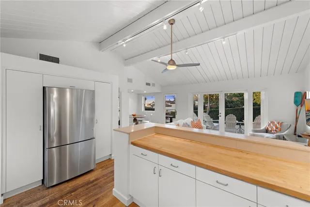 a kitchen with stainless steel appliances granite countertop a refrigerator a sink and a stove