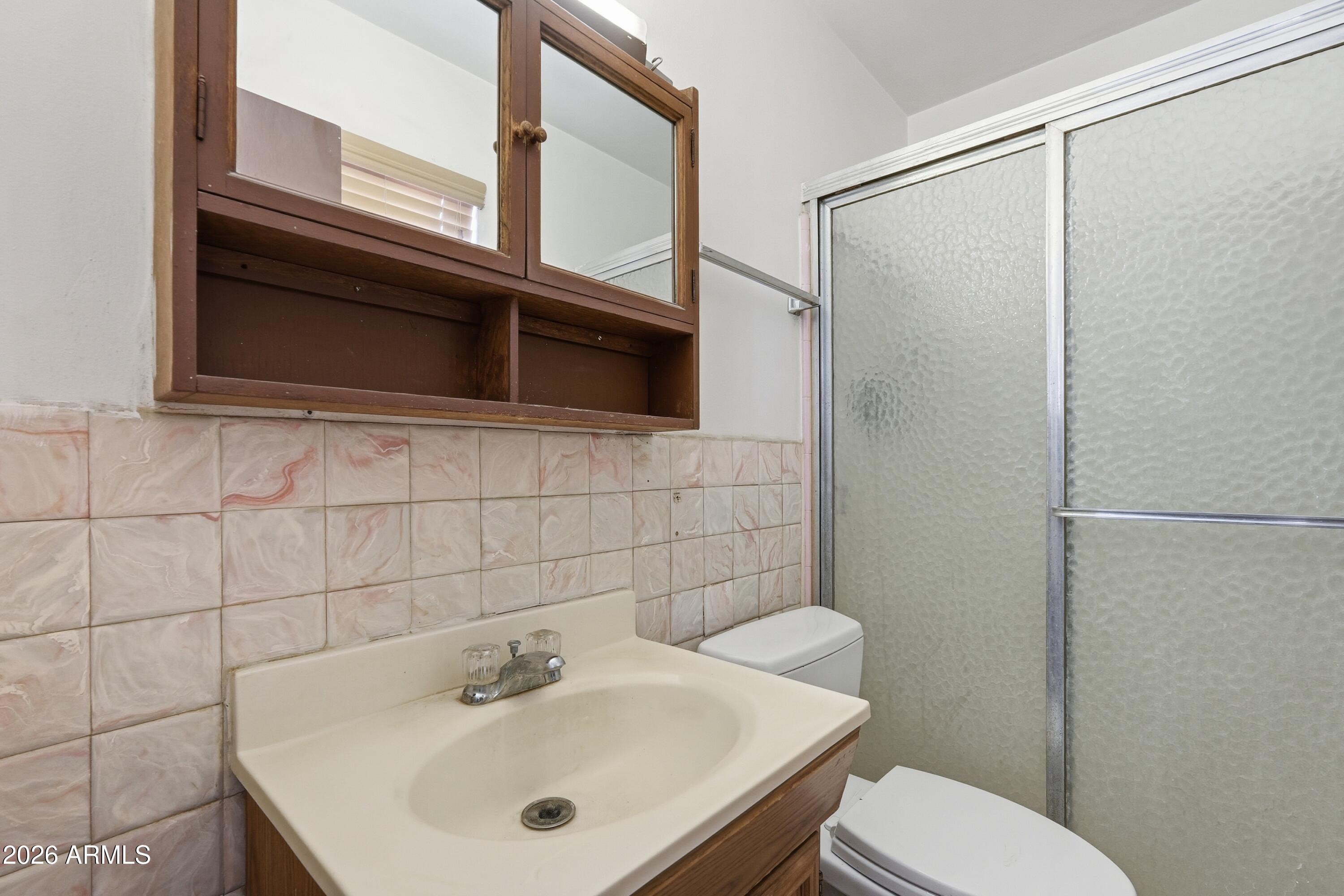 1120 West Romo Jones Street Tempe, AZ 85281 - Photo 12 of 18 a bathroom with a sink a toilet and shower