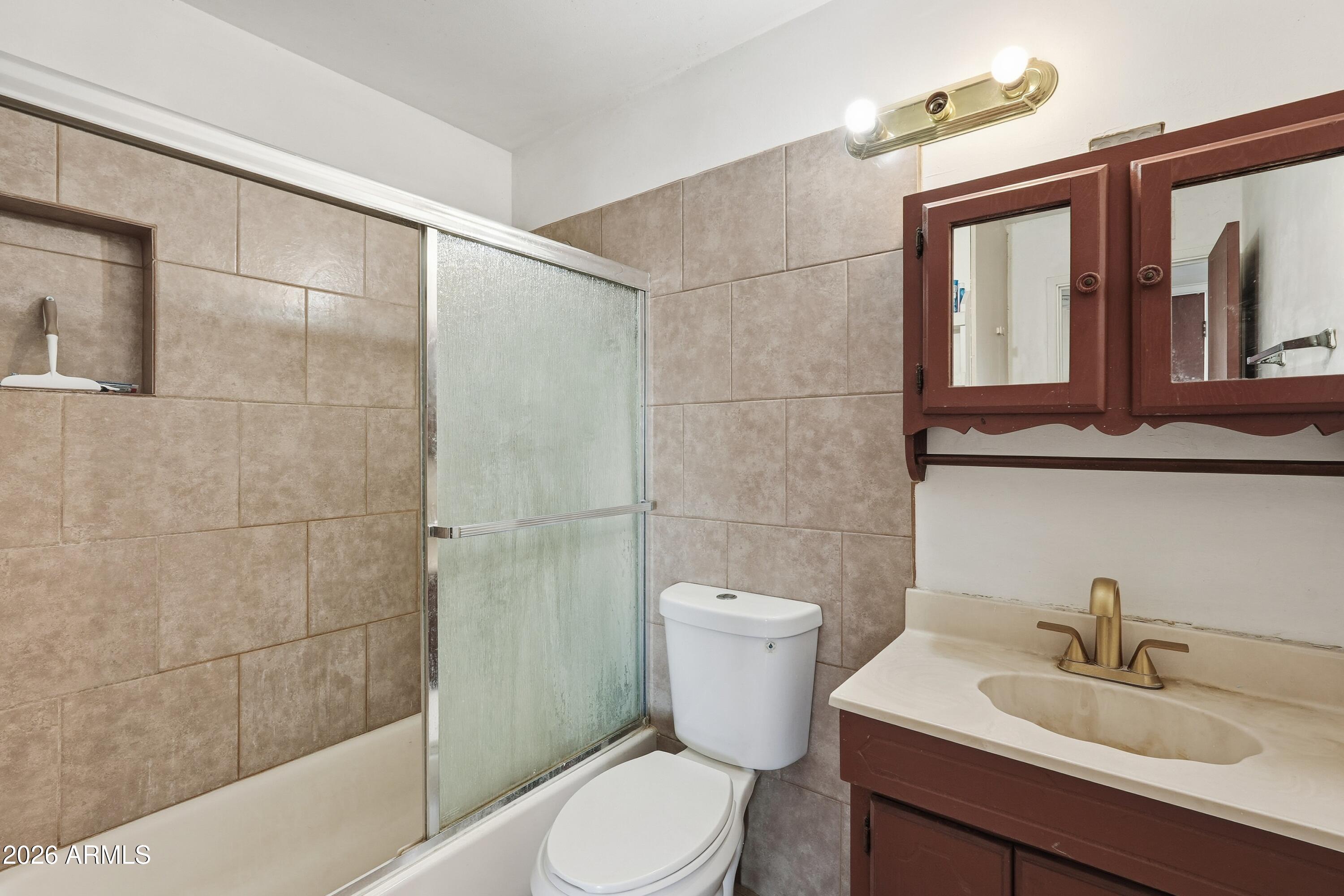 1120 West Romo Jones Street Tempe, AZ 85281 - Photo 15 of 18 a bathroom with a sink a toilet and shower