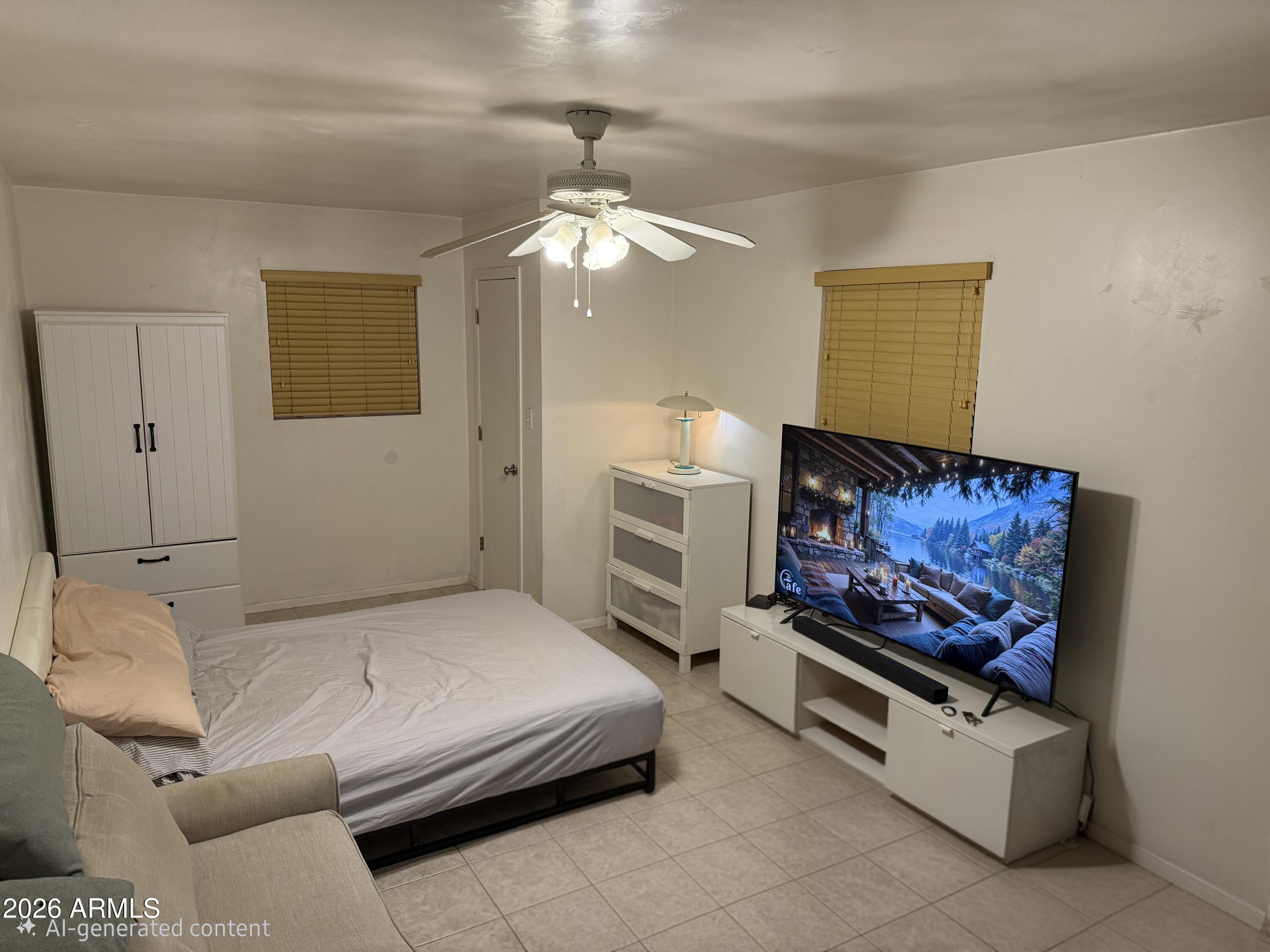 1120 West Romo Jones Street Tempe, AZ 85281 - Photo 16 of 18 a bedroom with a bed couch and window