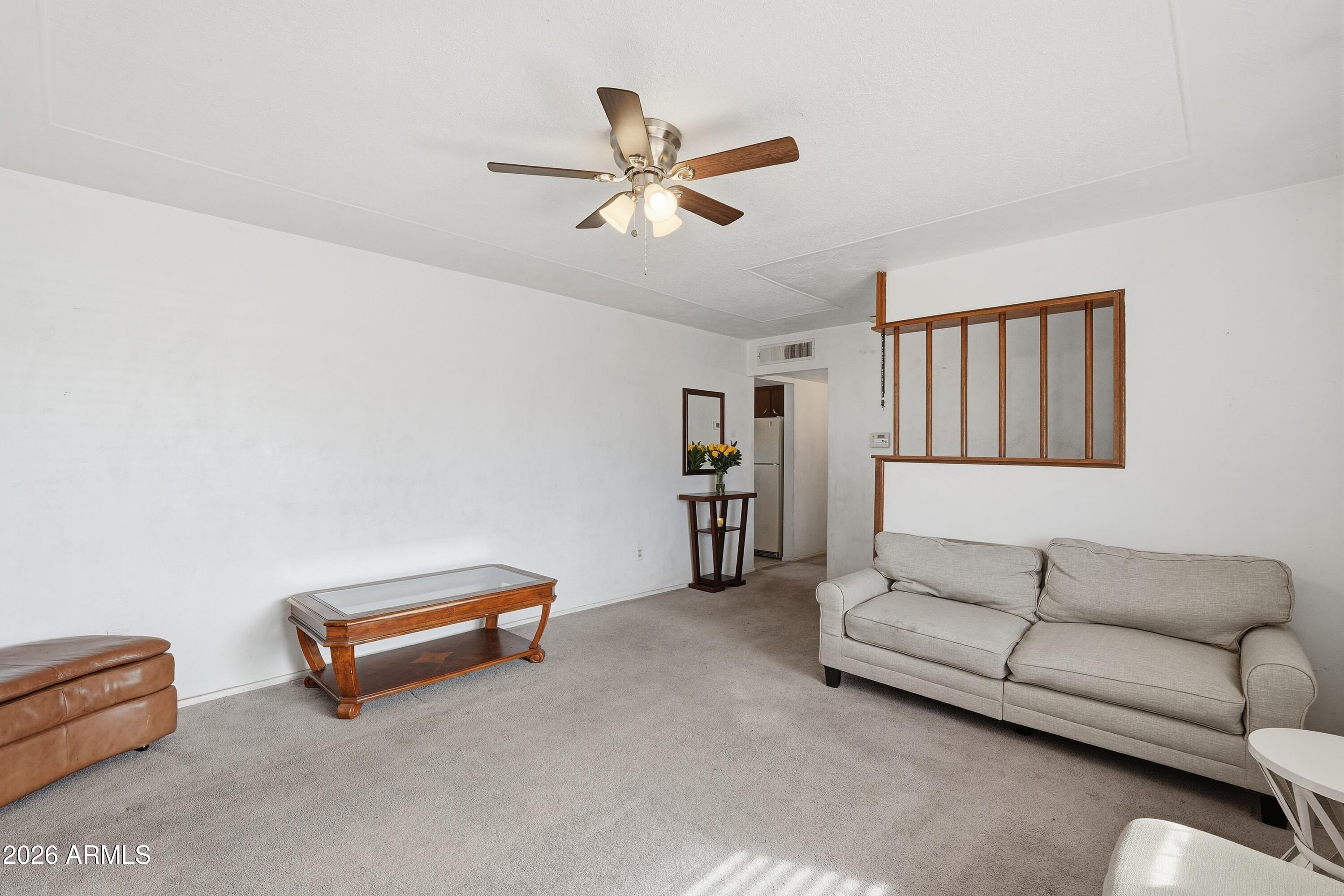 1120 West Romo Jones Street Tempe, AZ 85281 - Photo 5 of 18 a living room with furniture and a ceiling fan