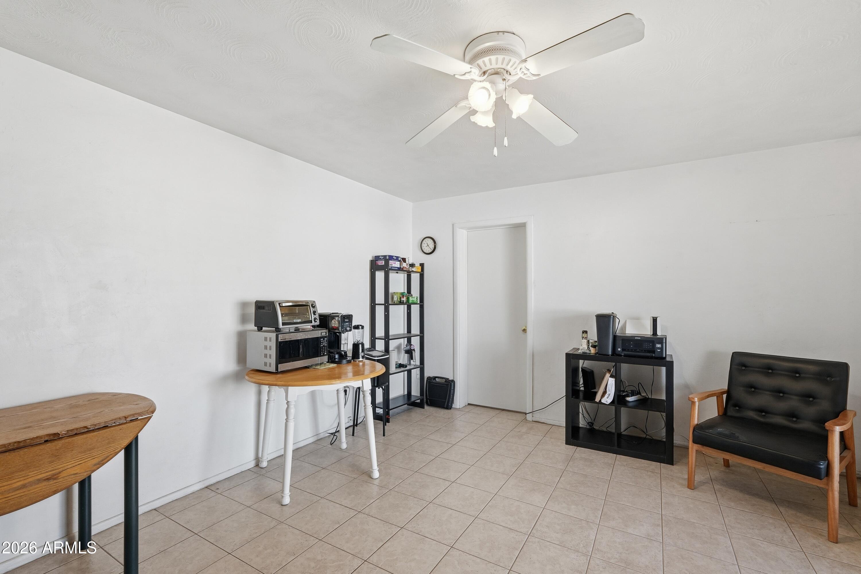 1120 West Romo Jones Street Tempe, AZ 85281 - Photo 7 of 18 a view of a workspace with furniture and a chandelier