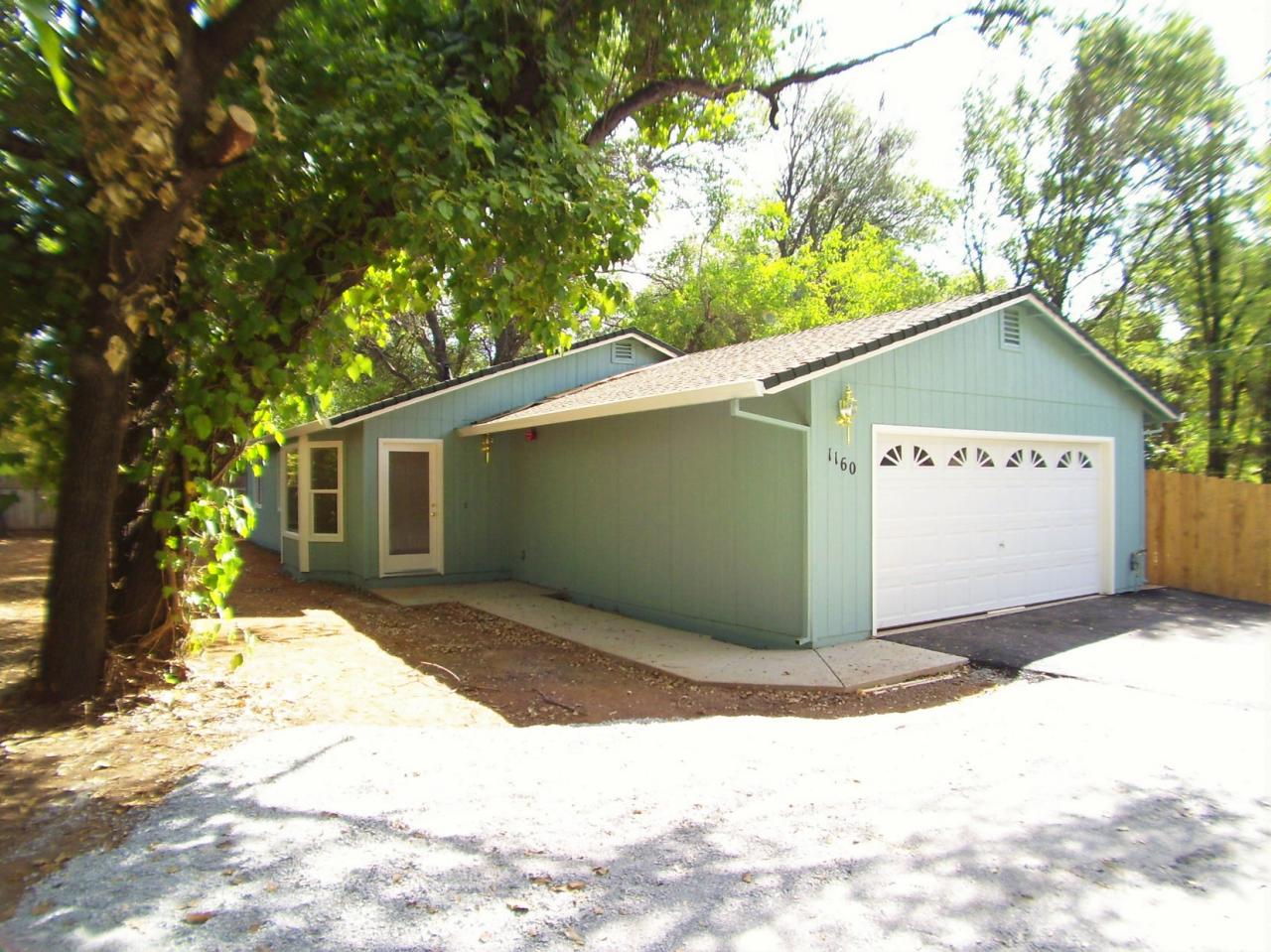 1160 Echo Road Redding, CA 96002 - Photo 1 of 15 a view of backyard with a tree and wooden fence