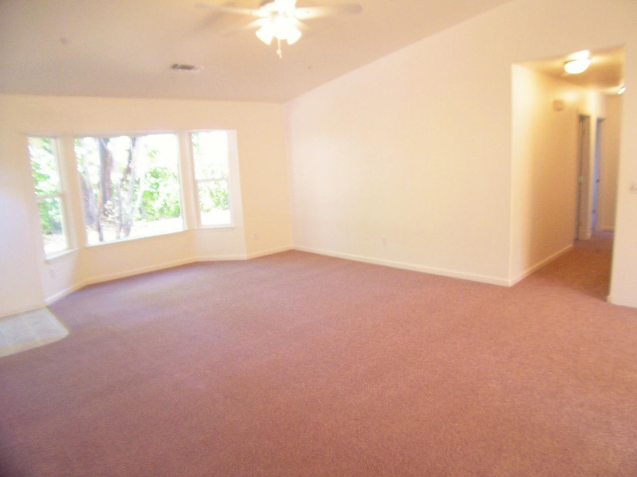 1160 Echo Road Redding, CA 96002 - Photo 6 of 15 an empty room with windows and city view