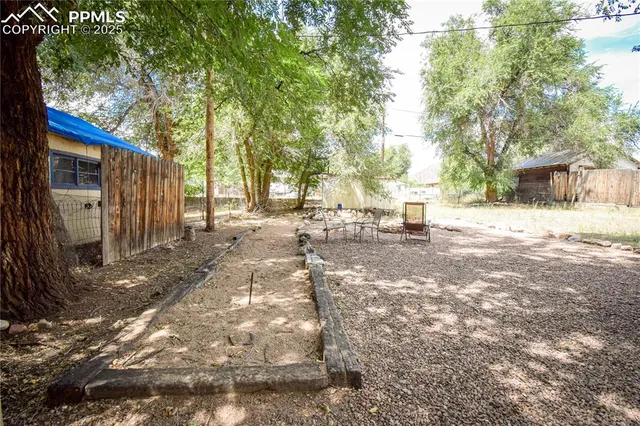 a view of a yard with large trees