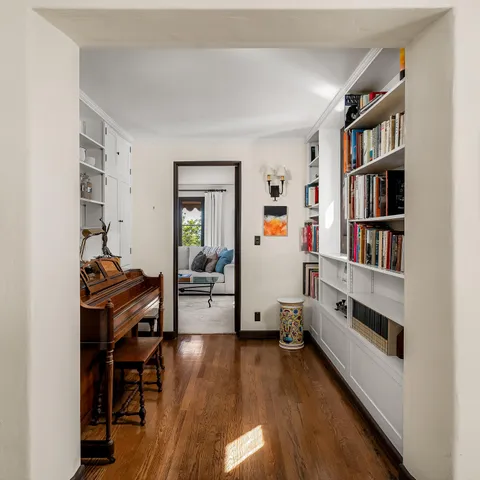 a view of a workspace with furniture and wooden floor