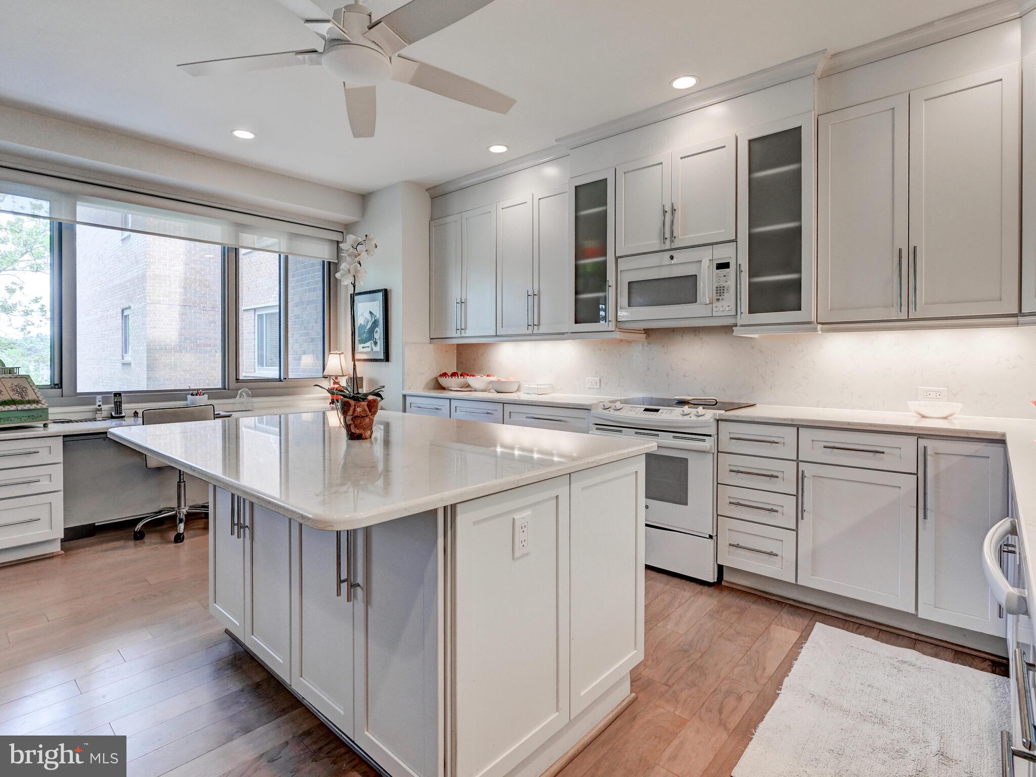 11 Slade Avenue, Unit 410 Pikesville, MD 21208 - Photo 12 of 32 a kitchen with granite countertop a sink appliances cabinets and furniture