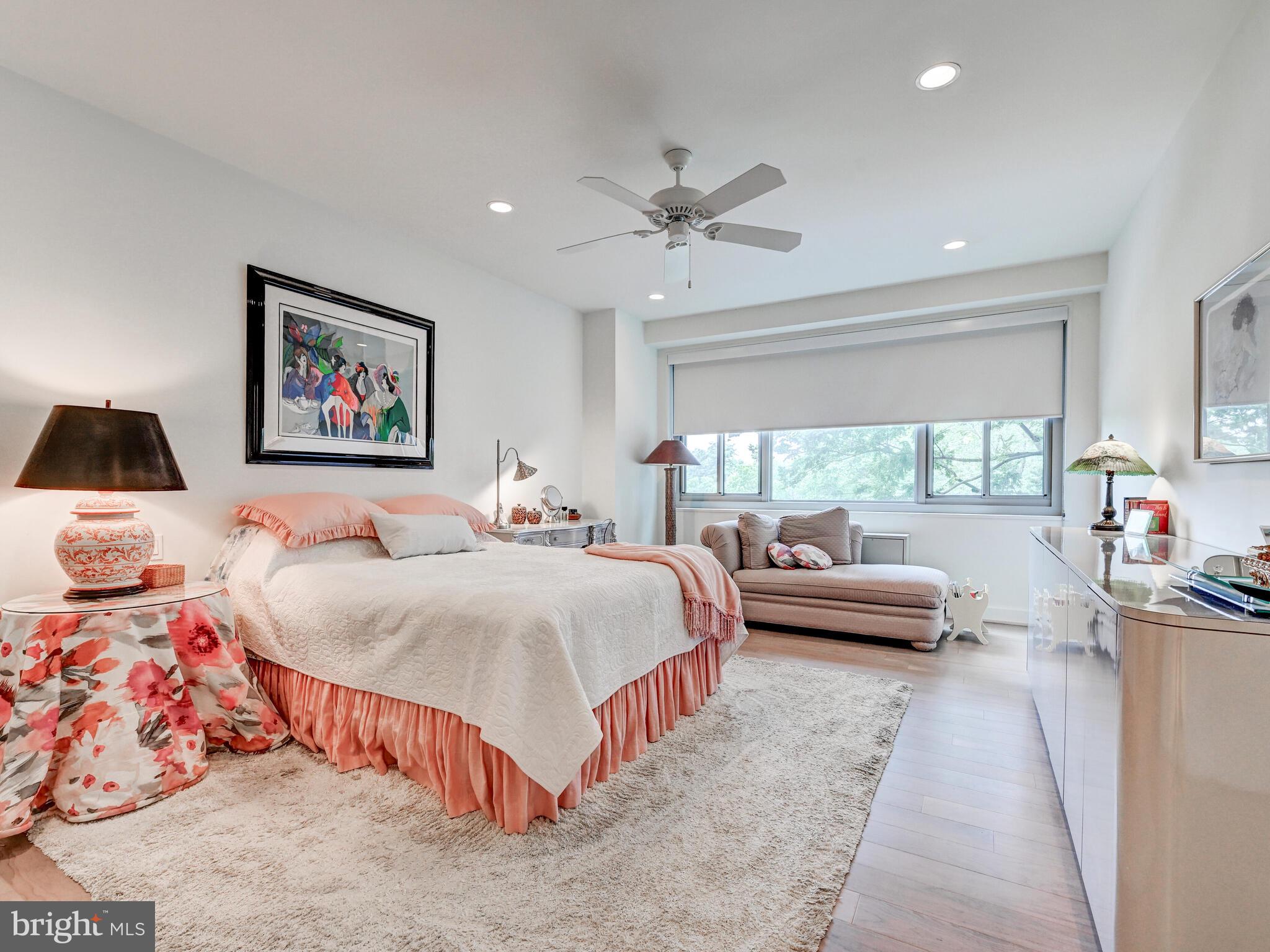 11 Slade Avenue, Unit 410 Pikesville, MD 21208 - Photo 13 of 32 a spacious bedroom with a large bed and a large window