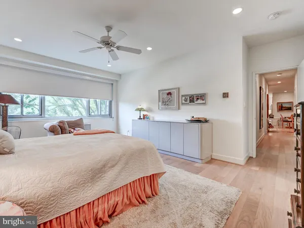 a spacious bedroom with a large bed and a large window