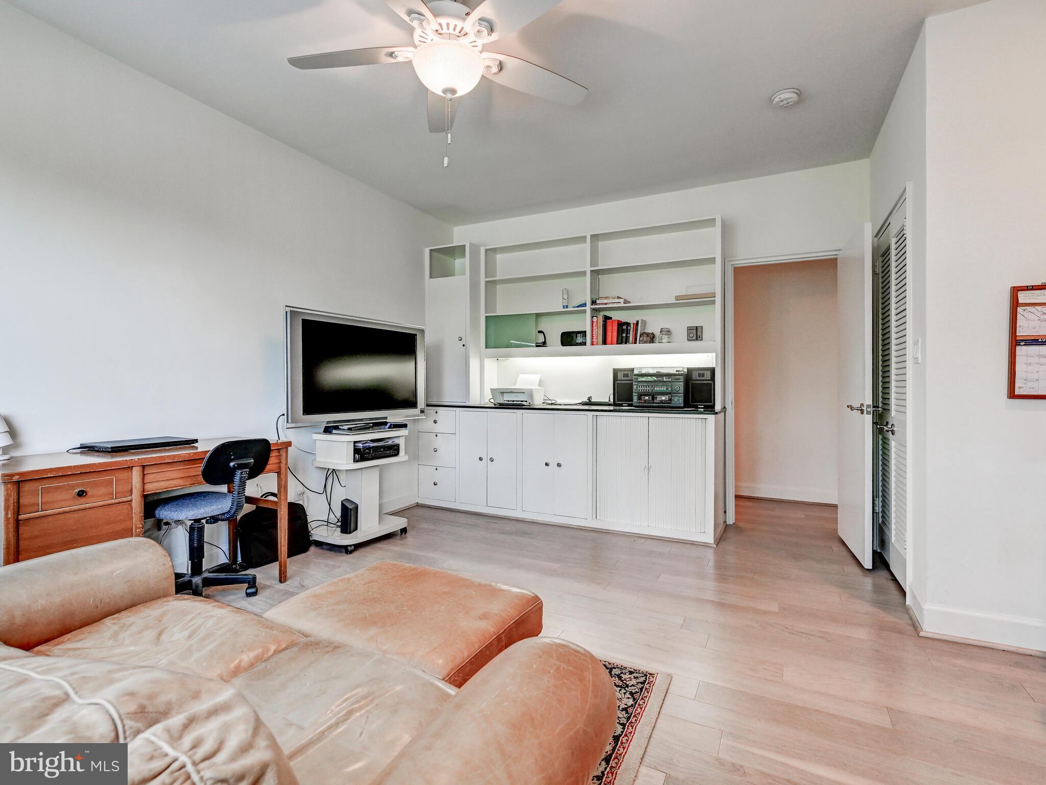 11 Slade Avenue, Unit 410 Pikesville, MD 21208 - Photo 18 of 32 a living room with furniture and a flat screen tv