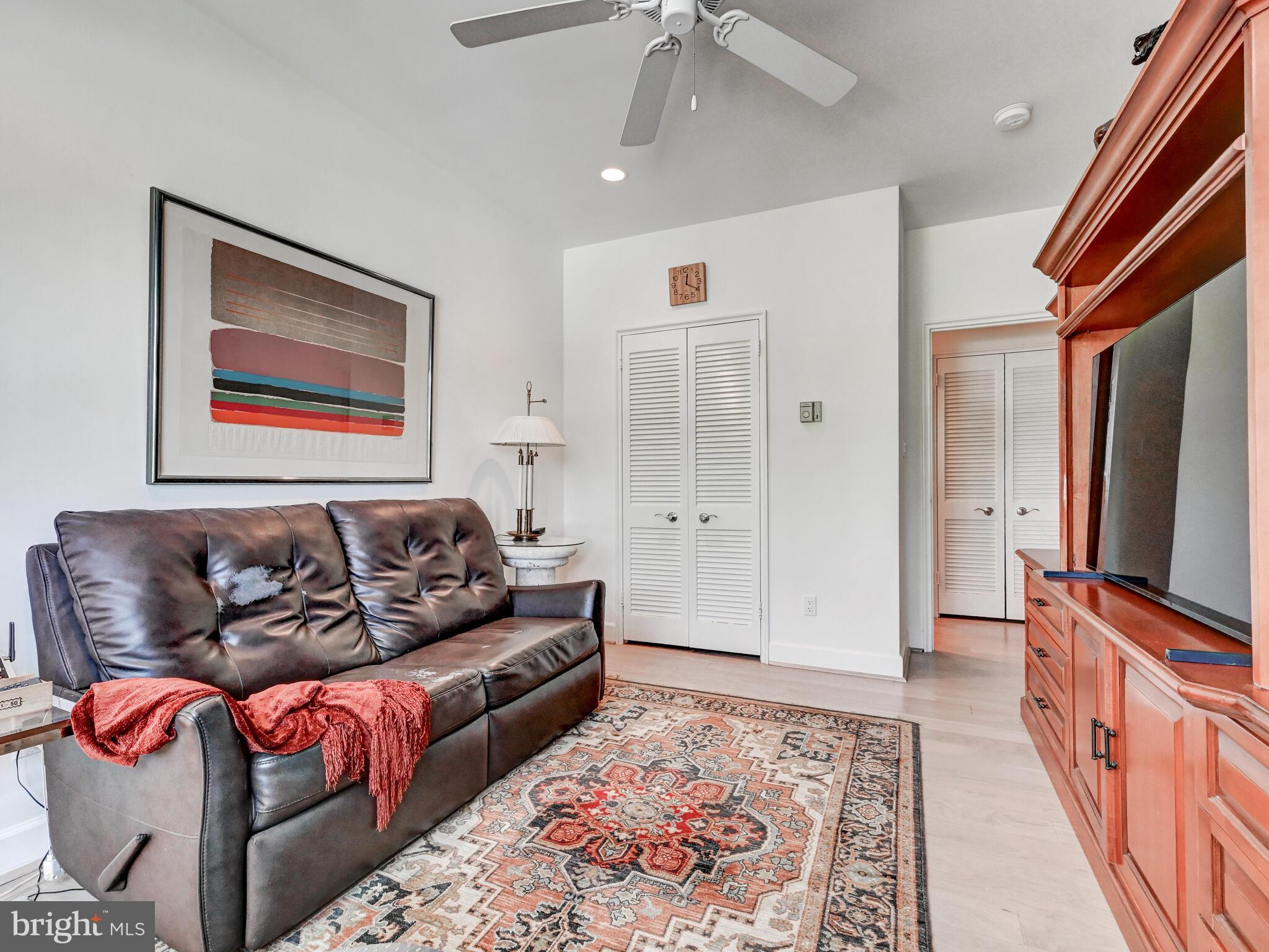 11 Slade Avenue, Unit 410 Pikesville, MD 21208 - Photo 20 of 32 a living room with furniture and a flat screen tv