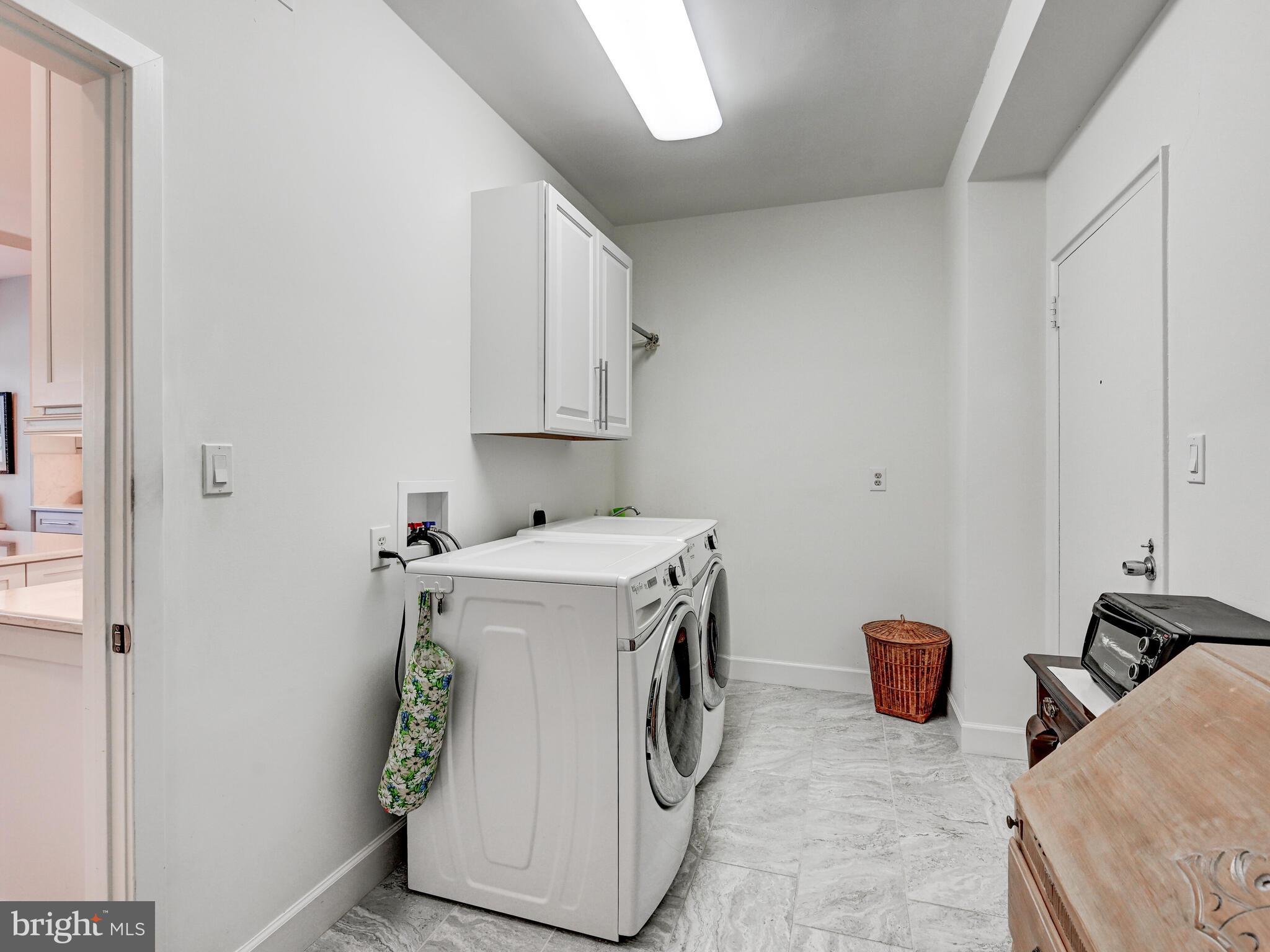 11 Slade Avenue, Unit 410 Pikesville, MD 21208 - Photo 22 of 32 a utility room with dryer and washer